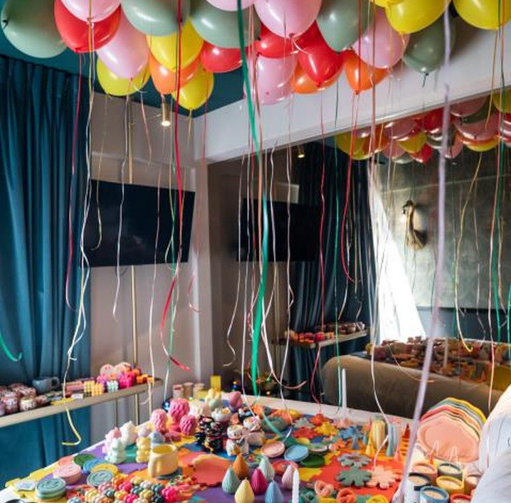Hotel room filled with balloons and handmade pieces at Fashion Room Service