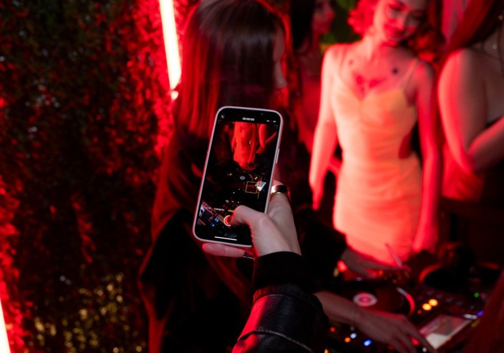 Guest filming the DJ at the Fashion Room Service after-party