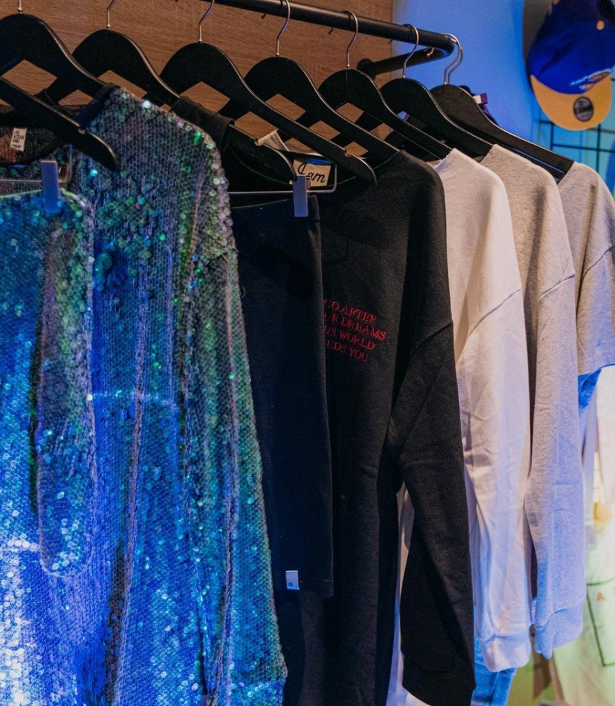 Rack of sequinned and printed garments in a Fashion Room Service room